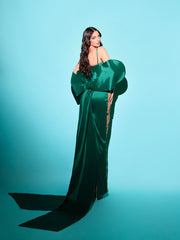 nude evening gown featuring a big green bow