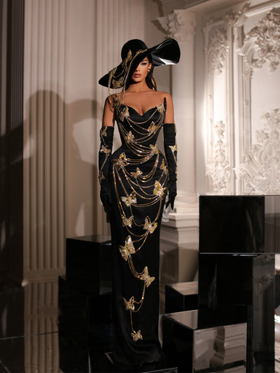 a black evening gown featuring a hat and butterfly details