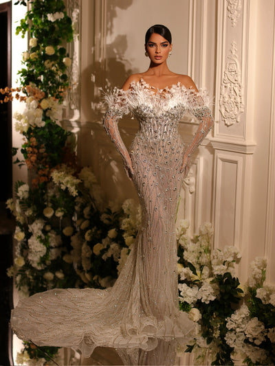 bridal gown featuring feathers and a long tail