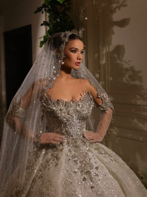 bridal ball gown featuring opera gloves and a veil