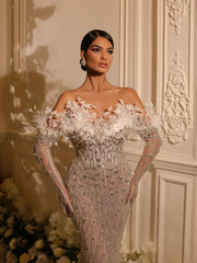 bridal gown  featuring feathers and a long tail