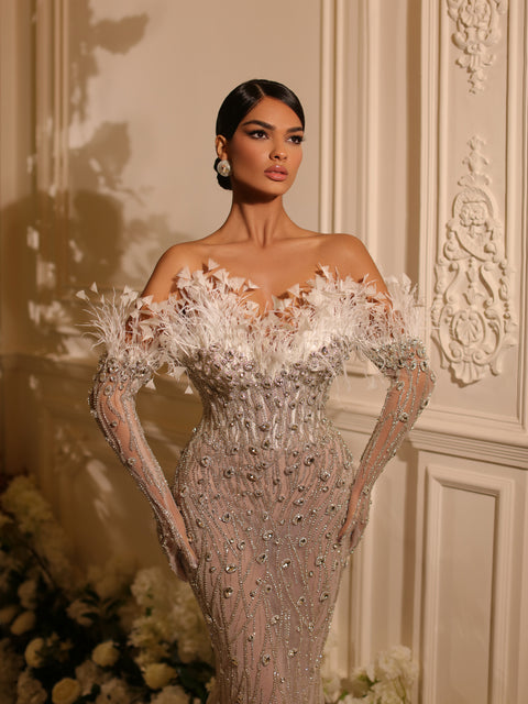 bridal gown  featuring feathers and a long tail