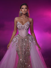 a light pink evening gown featuring a removable train