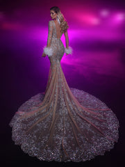 a nude evening gown featuring an open back and a long train