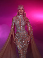 a nude evening gown featuring cape sleeves